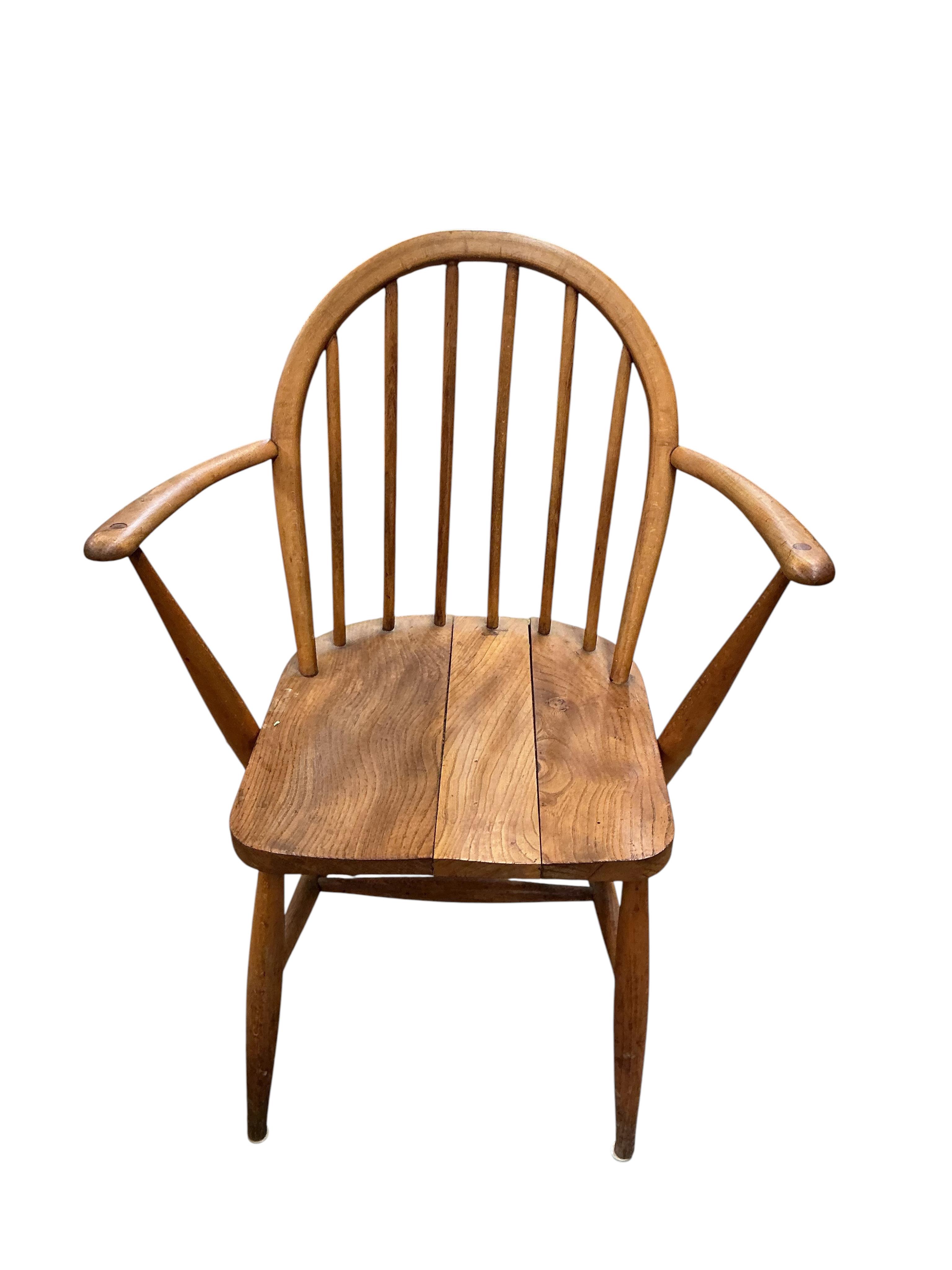 A pair of Ercol elm and beech comb back Windsor elbow chairs, width 60cm, depth 40cm, height 86cm